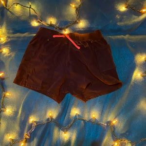 black athletic shorts with pockets and built in underwear with pink pull strings